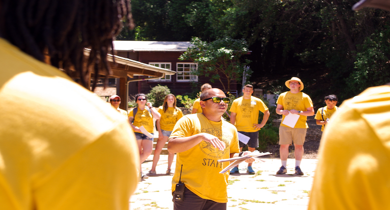 Camp staff standing in a circle talking